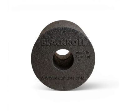 Round black Blackroll tool with a central hollow hole and embossed branding (made in Germany).