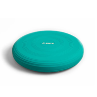 Turquoise plastic frisbee with concentric rings and the brand name AYTE at the center, resting on a white surface.